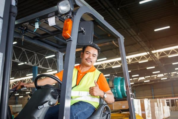 Forklift Operator Giving A Thumbs Up After Checking His Surroundings for Safety Hazards