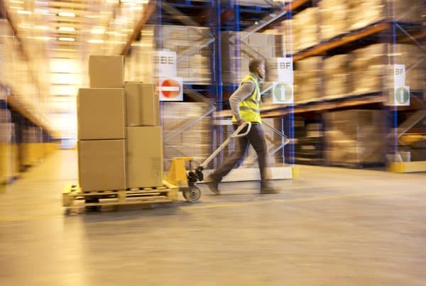 Warehouse Worker Moving a Pallet - Improve Warehouse Ergonomics