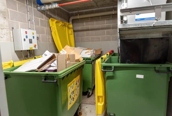 Image of a Tightly Packed Trash Room in Need of a Motorized Dumpster Tow